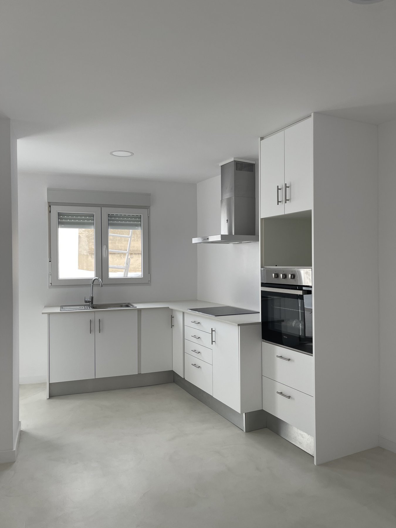 Cocina en L reformada con microcemento en Pedreguer